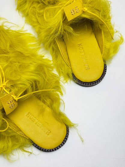 Yellow fur clogs texture close up